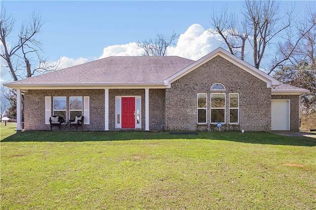 ranch-style house featuring a garage, a shingled roof, a front lawn, and brick siding