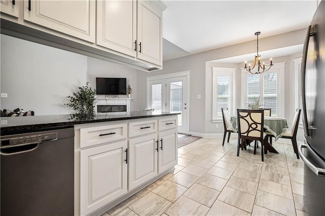 kitchen with white cabinetry, hanging light fixtures, freestanding refrigerator, dishwasher, and an inviting chandelier