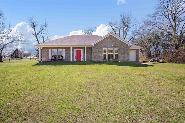 ranch-style home featuring a garage, brick siding, and a front lawn