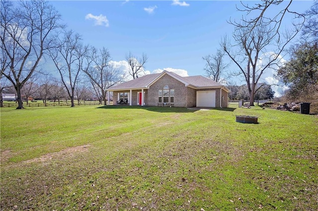 single story home featuring a garage, driveway, a front lawn, and brick siding