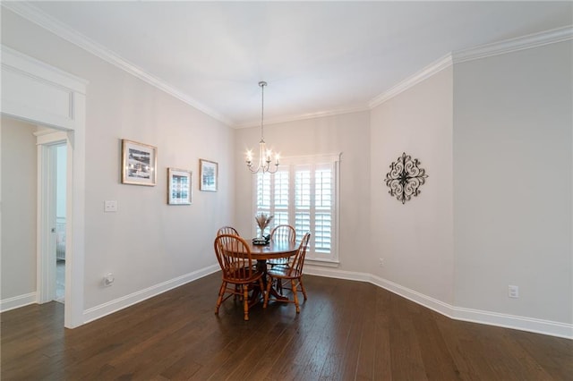 dining area with dark hardwood / wood-style flooring, crown molding, and an inviting chandelier