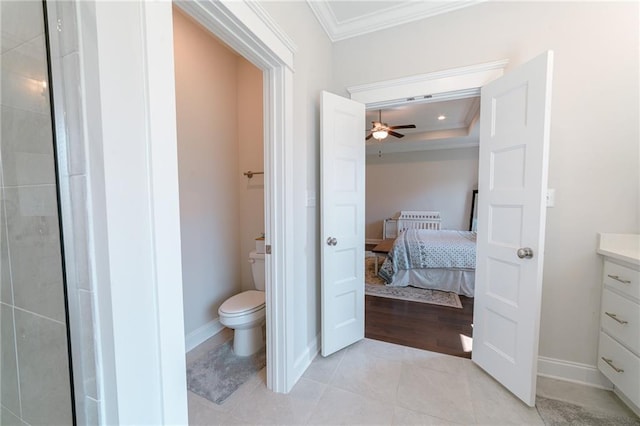 bathroom featuring ceiling fan, tile patterned floors, crown molding, toilet, and vanity