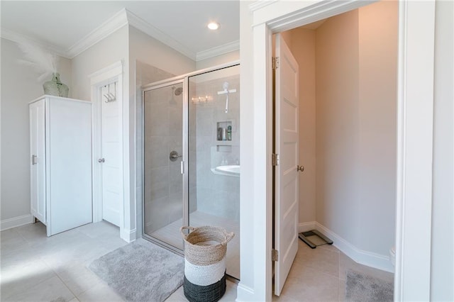 bathroom featuring tile patterned floors, crown molding, and a shower with door