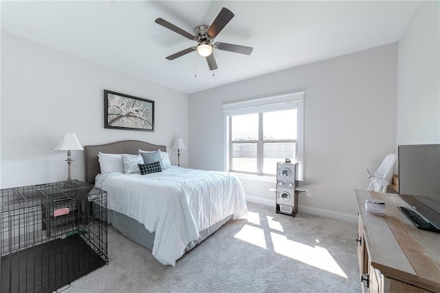 bedroom featuring ceiling fan and light carpet