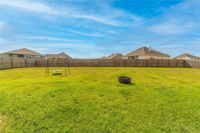 view of yard featuring a fire pit and a playground