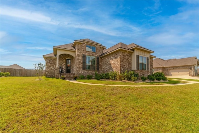 view of front of house featuring a front yard and a garage