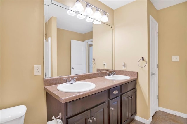 bathroom featuring vanity, toilet, and tile patterned flooring