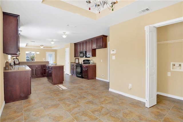 kitchen featuring sink, a center island, dark brown cabinets, black range with electric stovetop, and ceiling fan with notable chandelier