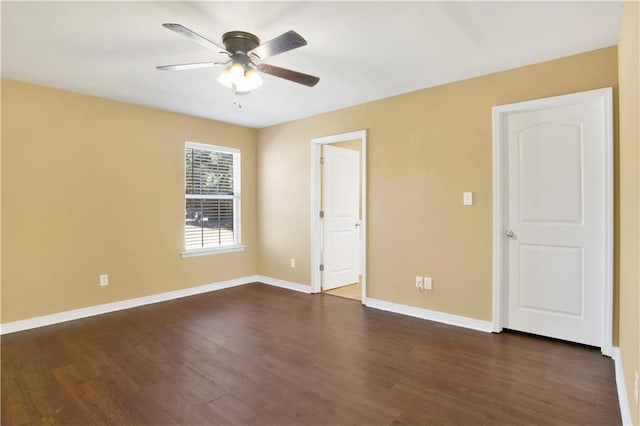 unfurnished room with dark hardwood / wood-style floors and ceiling fan