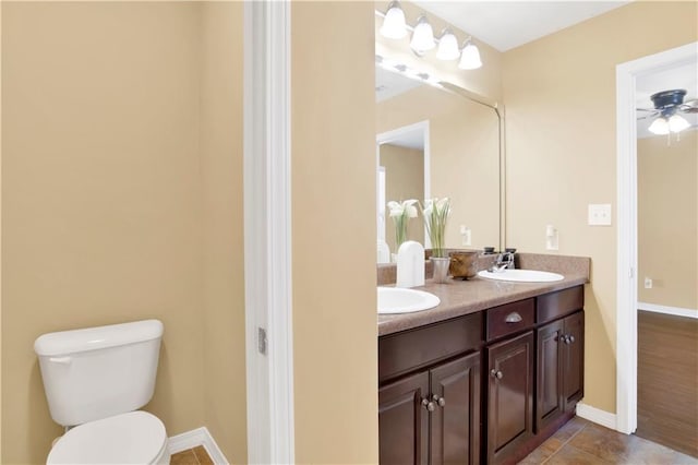 bathroom with vanity, ceiling fan, and toilet