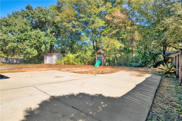 view of patio / terrace with a shed and a playground