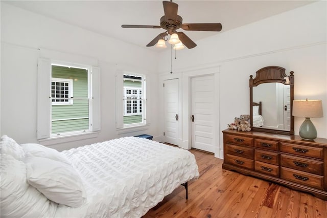 bedroom with ceiling fan and light wood-style flooring