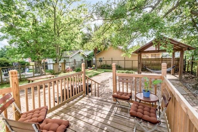 wooden terrace featuring a fenced backyard and a gazebo