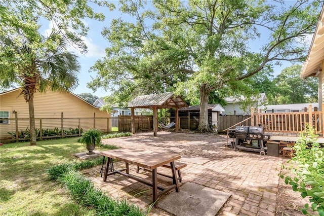 view of patio featuring a gazebo and a fenced backyard