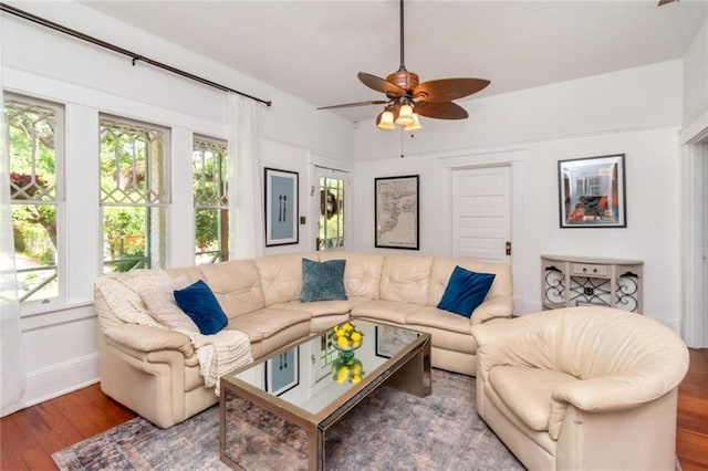 living room with baseboards, a ceiling fan, and wood finished floors