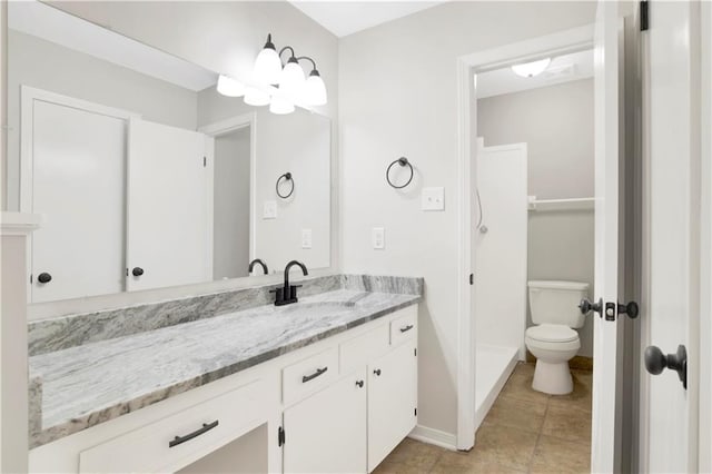 bathroom featuring vanity, toilet, and tile patterned flooring