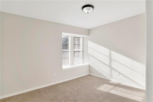 spare room featuring light colored carpet