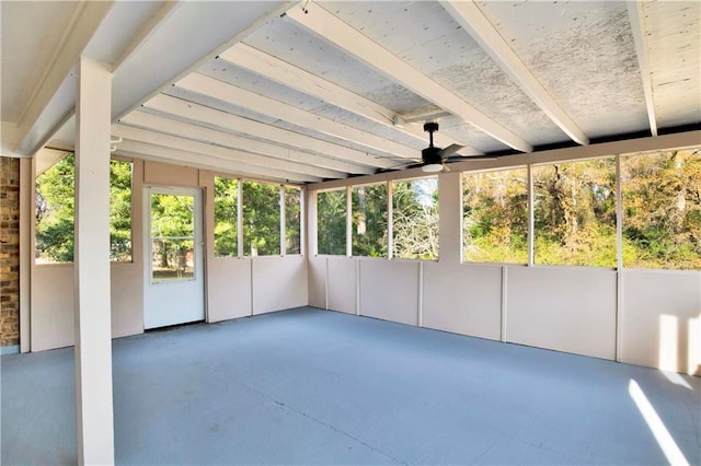 unfurnished sunroom featuring ceiling fan