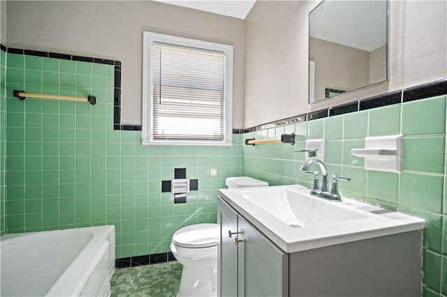 full bath with vanity, tile walls, and toilet