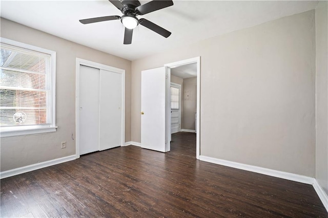 unfurnished bedroom with a closet, ceiling fan, baseboards, and wood finished floors