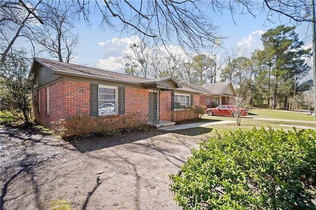 ranch-style house with brick siding and driveway