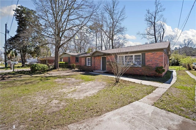 single story home featuring brick siding and a front lawn