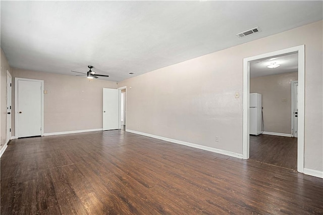 unfurnished living room with ceiling fan, visible vents, baseboards, and wood finished floors