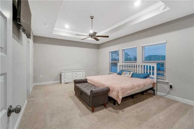 carpeted bedroom featuring crown molding, ceiling fan, and a tray ceiling