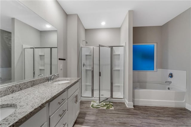 bathroom featuring vanity, wood-type flooring, and independent shower and bath