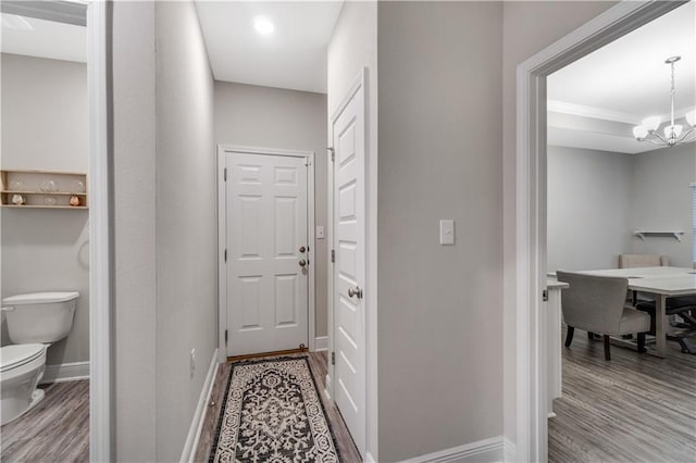 interior space featuring an inviting chandelier and light hardwood / wood-style flooring