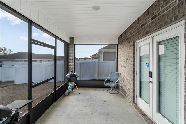 sunroom / solarium featuring french doors