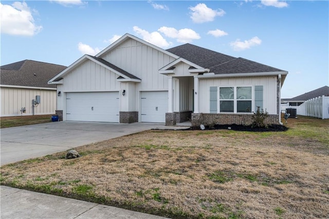 view of front of property with central AC unit, a garage, and a front yard