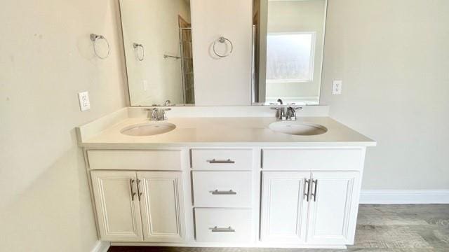 10706 Relic Rd N, Mobile, AL 36608 - bathroom featuring double vanity and wood finished floors
