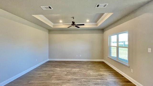 10706 Relic Rd N, Mobile, AL 36608 - unfurnished room with a tray ceiling, ceiling fan, crown molding, wood finished floors, and recessed lighting