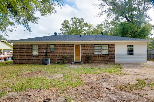 back of house with central AC unit