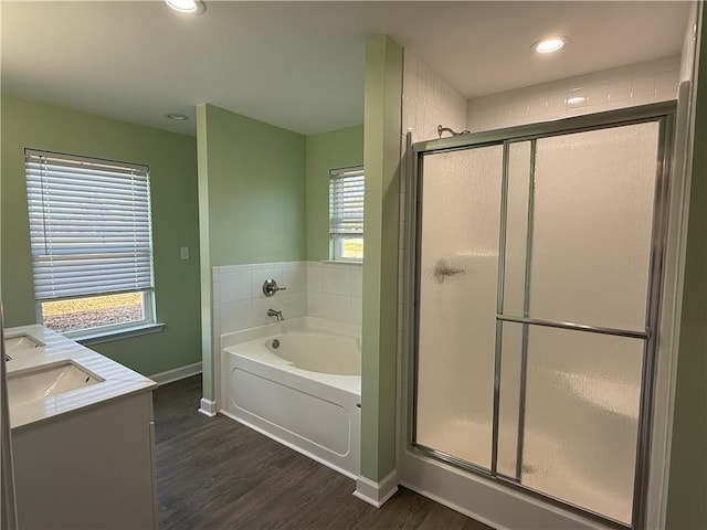 bathroom featuring hardwood / wood-style floors, vanity, plenty of natural light, and shower with separate bathtub