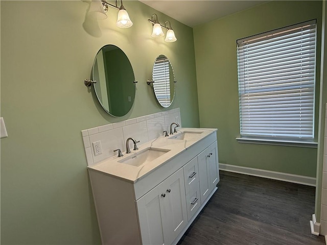 bathroom with decorative backsplash, wood-type flooring, and vanity