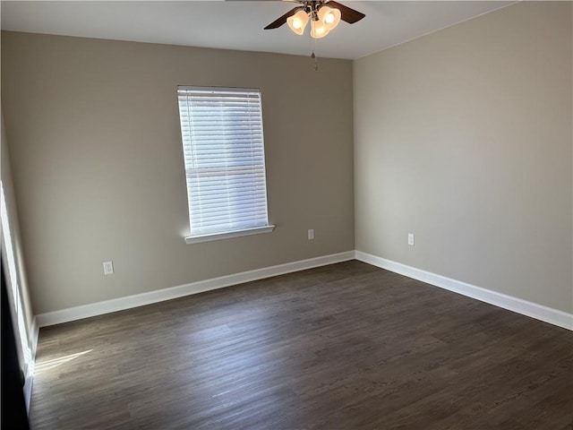 spare room with ceiling fan and dark wood-type flooring