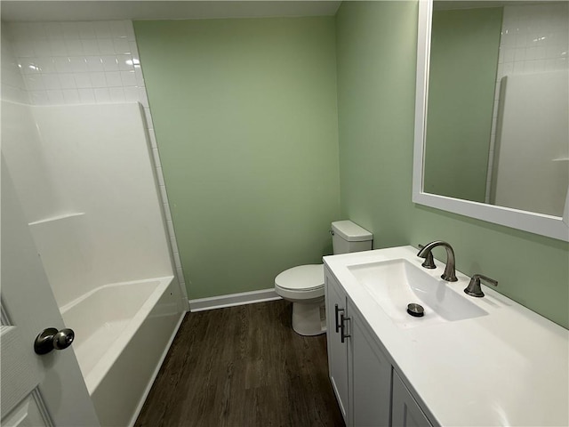 full bathroom with bathing tub / shower combination, toilet, vanity, and hardwood / wood-style flooring