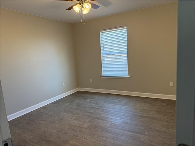 spare room featuring ceiling fan and dark hardwood / wood-style flooring