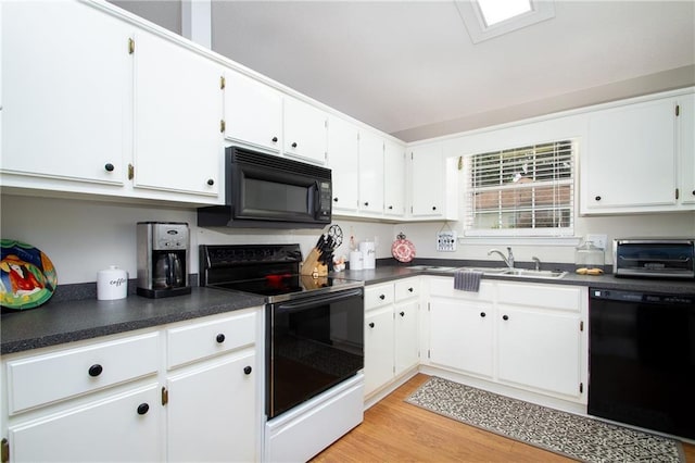 1000 Pinemont Dr, Mobile, AL 36609 - kitchen featuring black appliances, dark countertops, light wood-style flooring, and white cabinetry