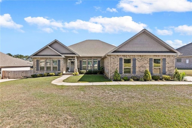 craftsman-style home featuring a front lawn