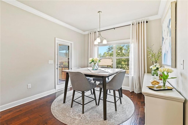 dining room with dark hardwood / wood-style flooring, ornamental molding, and a notable chandelier