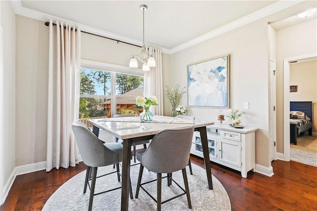 dining area with crown molding, dark wood-type flooring, and a chandelier