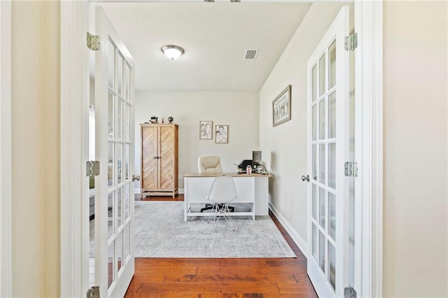 office space featuring wood-type flooring and french doors