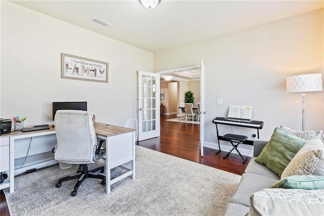 home office with dark hardwood / wood-style flooring and french doors