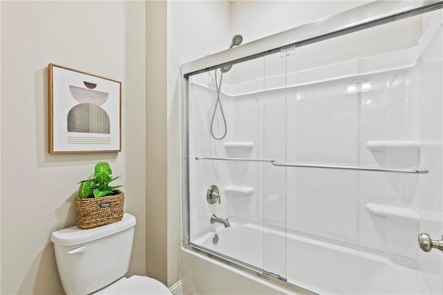 bathroom featuring shower / bath combination with glass door and toilet