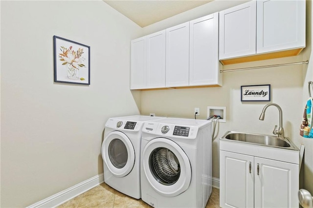 laundry area with sink, light tile patterned floors, cabinets, and independent washer and dryer