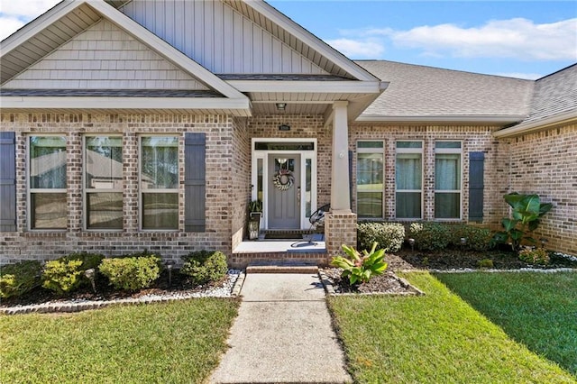 doorway to property with a lawn