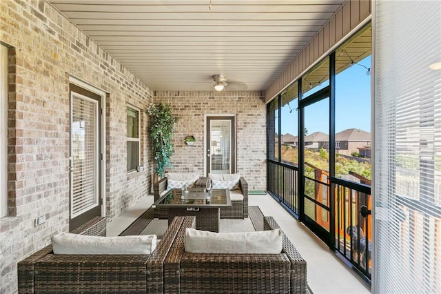 sunroom with ceiling fan and wood ceiling